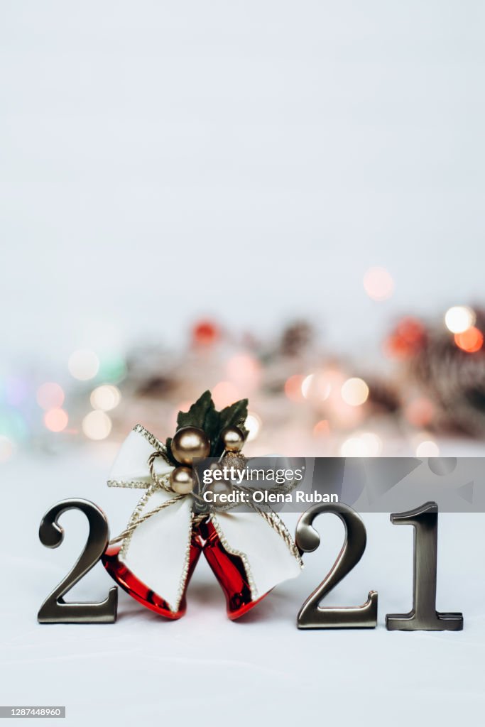 Numbers 2021 and bright christmas bell with gold ribbon