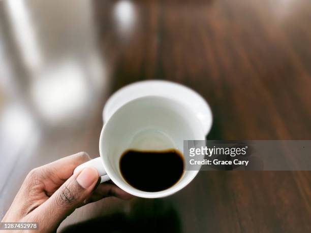 woman enjoys cup of coffee - black cup saucer stock pictures, royalty-free photos & images