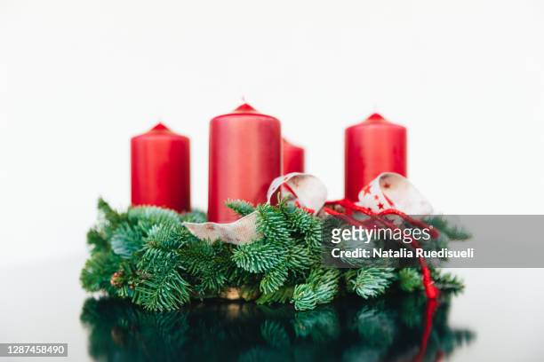 traditional advent wreath in switzerland made of fir-tree branches with four red candles. - natalia star stock pictures, royalty-free photos & images
