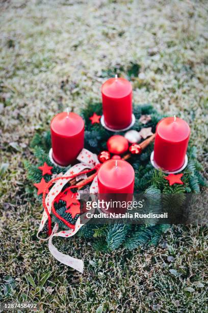 advent wreath made of fir-tree branches with four red candles. christmas tradition in switzerland. - advent wreath stock pictures, royalty-free photos & images