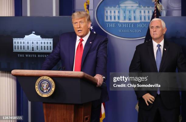 President Donald Trump speaks as Vice President Mike Pence looks on in the James Brady Press Briefing Room at the White House on November 24, 2020 in...