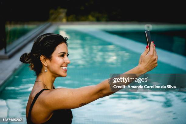 woman enjoying luxury pool - amanda blue stock pictures, royalty-free photos & images