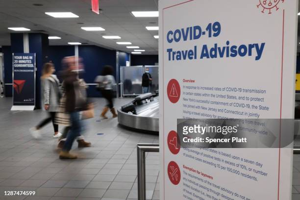Signs warn travelers of Covid-19 in New York’s LaGuardia Airport on November 24, 2020 in New York City. Despite warnings from the government and...