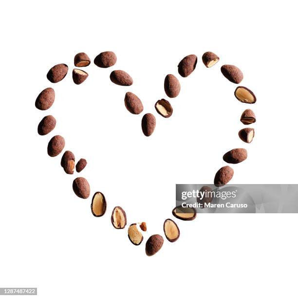 chocolate covered almonds in heart shape - chocolate dipped fotografías e imágenes de stock