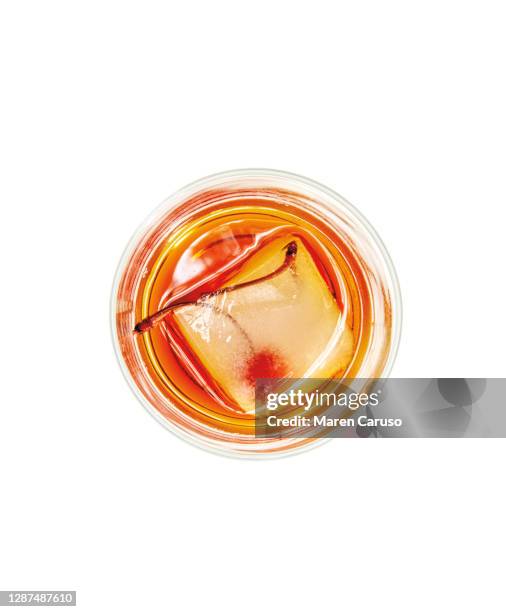 manhattan cocktail with cherry and ice cube - cocktail isolated stock pictures, royalty-free photos & images