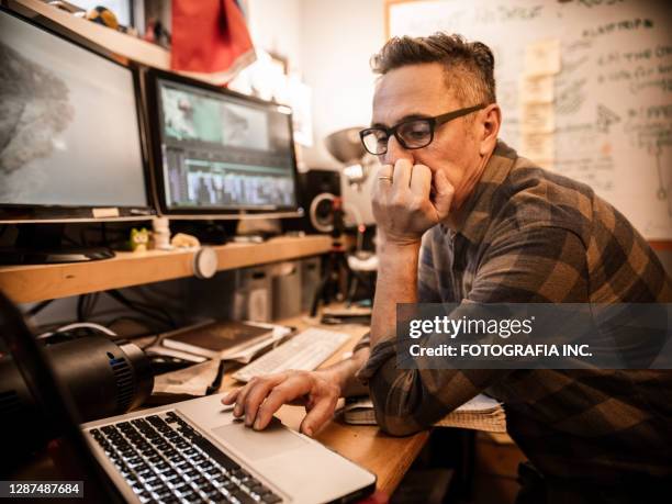 male video editor working at home - film editor stock pictures, royalty-free photos & images