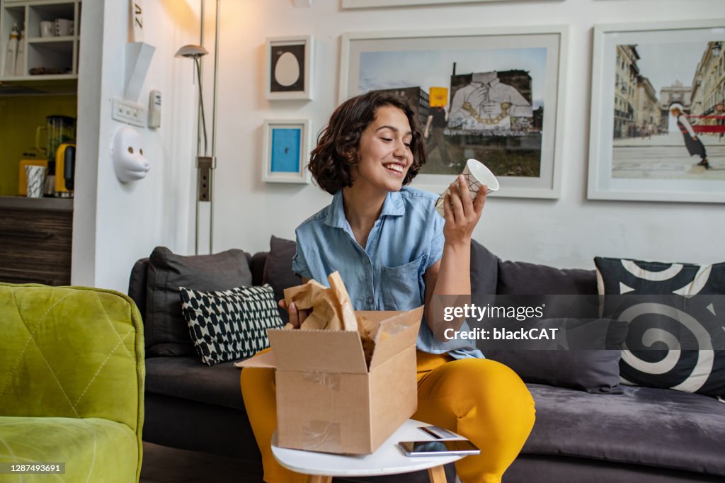 Young woman unpack the package she ordered online