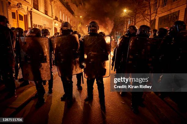 French riot police face protestors as demonstrations against police brutality and treatment of refugees in the city turn violent near Place de la...