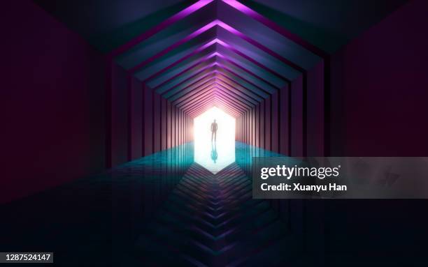 man standing in empty futuristic passage - neon tunnel stock pictures, royalty-free photos & images