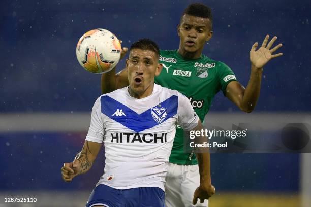 Ricardo Centurión of Velez competes for the ball with Darwin Andrade of Deportivo Cali during a round of sixteen first leg match between Velez and...