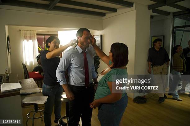 The makeup team prepares actor Erick Hayser before the recording of a scene of "El Octavo Mandamiento" soup opera at the Argos studios in...