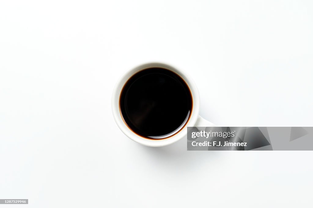 Close-up of cup of coffee on white background
