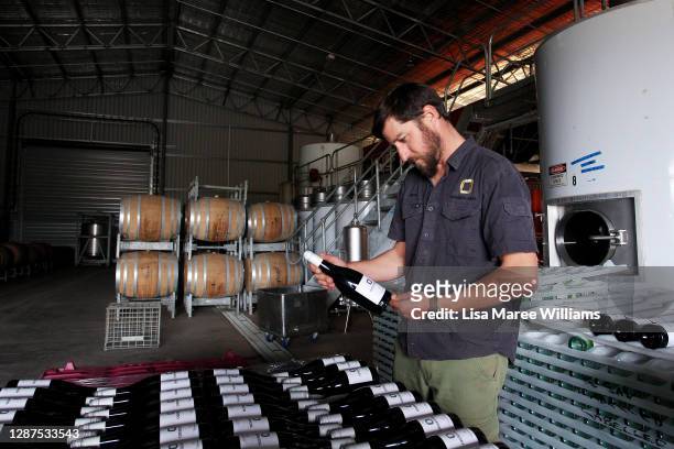 Adrian Brayne handles wine stock in the processing building at Obsession Wines on November 24, 2020 in Tumbarumba, Australia. Second-generation...