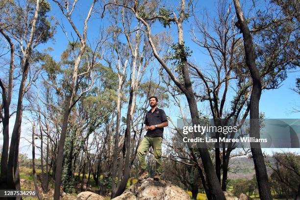 Adrian Brayne stands amongst bushfire-affected trees at his property on November 24, 2020 in Tumbarumba, Australia. Second-generation winemaker and...