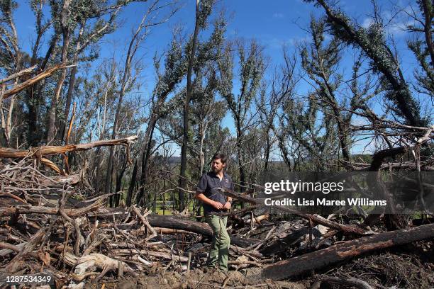 Adrian Brayne stands among bushfire-affected trees at his property on November 24, 2020 in Tumbarumba, Australia. Second-generation winemaker and...