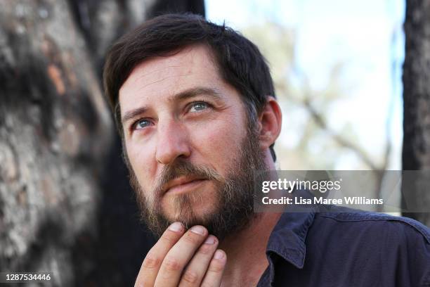 Adrian Brayne stands amongst bushfire-affected trees at his property on November 24, 2020 in Tumbarumba, Australia. Second-generation winemaker and...