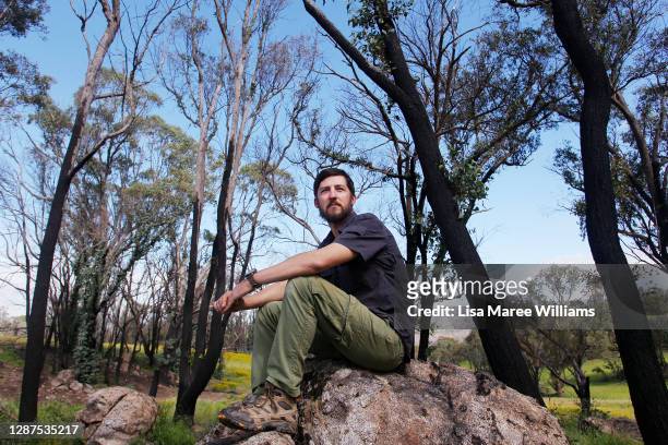 Adrian Brayne sits amongst bushfire-affected trees at his property on November 24, 2020 in Tumbarumba, Australia. Second-generation winemaker and...