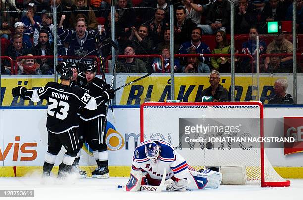 Teammates celebrate with Los Angeles Kings's Mike Richards as he scores against New York Rangers's goalie Henrik Lundqvist at their ice hockey NHL...