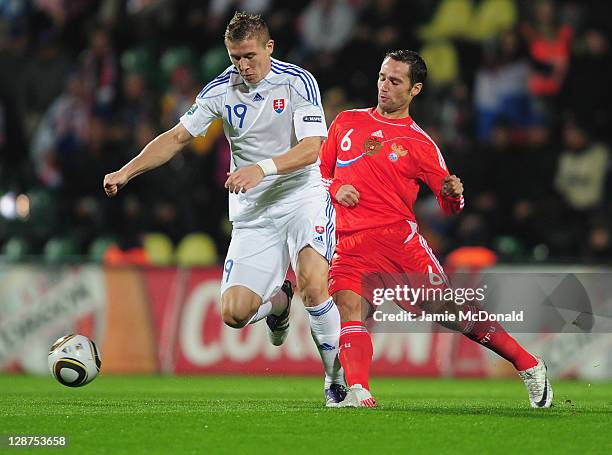 Juraj Kucka of Slovakia battles with Roman Sirokov of Russia during the EURO 2012, Group B qualifier between Slovakia and Russia at the MSK Zilina...