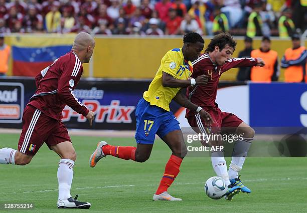 Ecuadorean forward Jaime Ayovi struggles for the ball with Venezuelan defender Jose Manuel Velasquez before the first Ecuadorean goal of a Brazil...