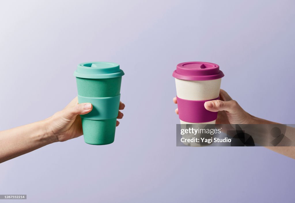 Reusable coffee cup in hand