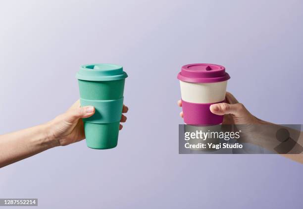 reusable coffee cup in hand - flask imagens e fotografias de stock