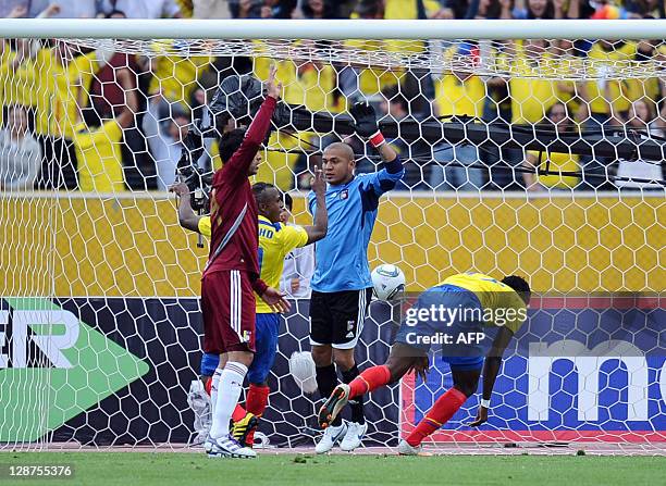 Ecuadorean forward Jaime Ayovi stumbles after scoring past Venezuelan goalkeeper Renny Vega during a Brazil 2014 FIFA World Cup South American...