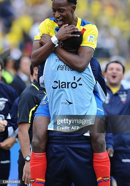 Ecuadorean forward Jaime Ayovi celebrates with a teammate after scoring against Venezuela during a Brazil 2014 FIFA World Cup South American...