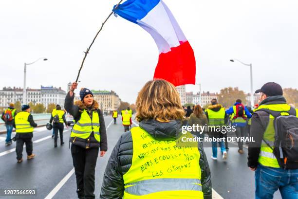 Jeune femme avec un drapeau français parmi des manifestants portant des gilets jaunes ont défilé dans le centre ville pour dénoncer la hausse de la...