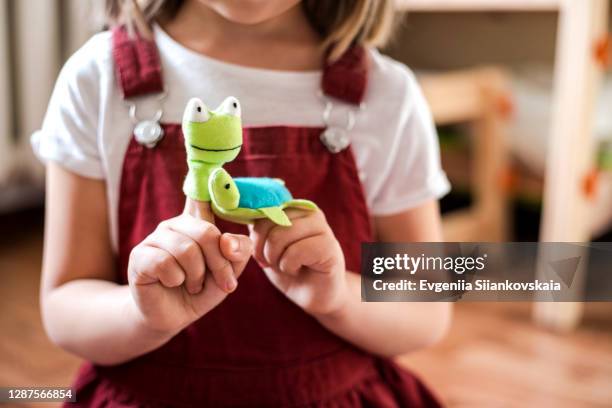 little girl with playing theater toys. - a turtles tale stock pictures, royalty-free photos & images