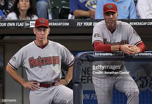 Bench coach Alan Trammell and manager Kirk Gibson of the Arizona Diamondbacks stand at the top of the dugout in the fourth inning as the Diamondbacks...