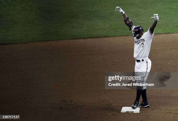 Nyjer Morgan of the Milwaukee Brewers celebrates with his team's 'Beast Mode' ritual after sliding safely into second base against the Arizona...