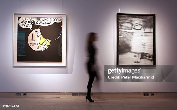 Christie's employee walks between Roy Lichtenstein's 'I Can See the Whole Room... And There's Nobody in It' and Gerhard Richter's 'Frau Niepenberg'...