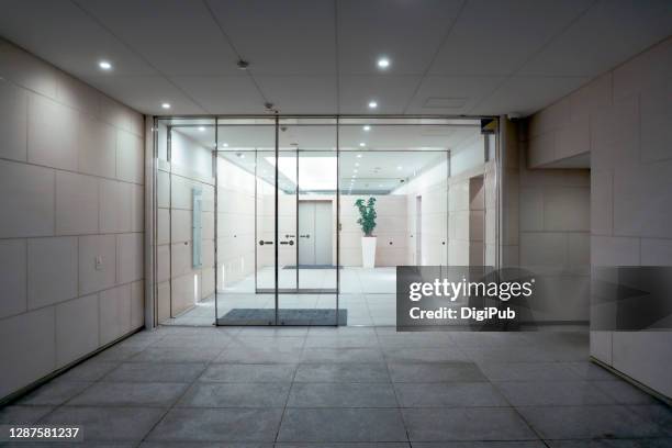 entrance of a building - sliding door stock-fotos und bilder