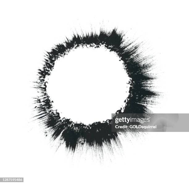 circle hand-painted on a white paper with a stiff brush and undiluted acrylic paint - brush movements are made from the outer border of the object to the outside, creating a lines resembling a big bang or black hole - abstract vector illustration - black hole stock illustrations