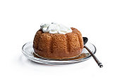 Rum baba decorated with whipped cream isolated on white