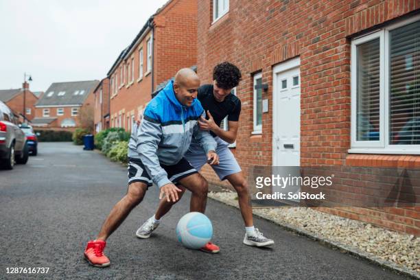 keeping fit with dad - british basketball stock pictures, royalty-free photos & images