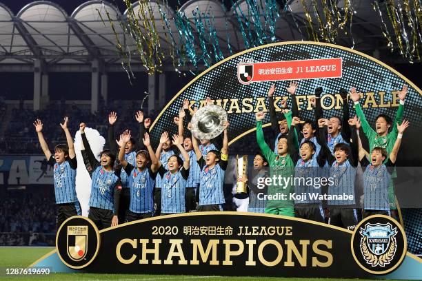 Kengo Nakamura of Kawasaki Frontale lifts the trophy as they celebrate the J1 Champions after the J.League Meiji Yasuda J1 match between Kawasaki...