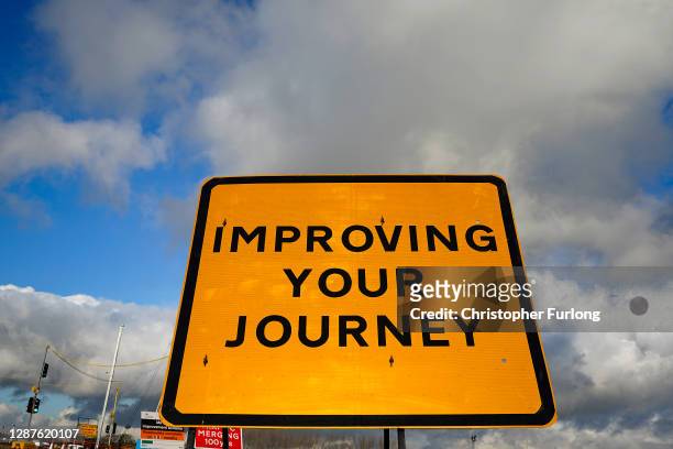 Road signs and traffic cones stand by roadworks and junction improvements at Junction 19 of the M6 motorway on November 25, 2020 in Knutsford,...