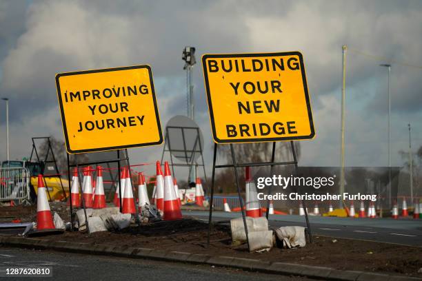 Road signs and traffic cones stand by roadworks and junction improvements at Junction 19 of the M6 motorway on November 25, 2020 in Knutsford,...