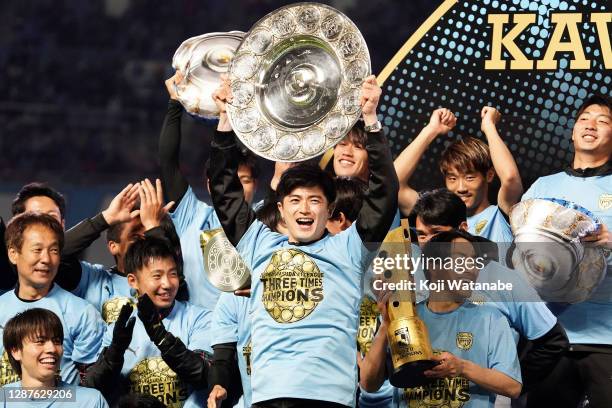 Shogo Taniguchi of Kawasaki Frontale lifts the trophy as they celebrate being the J1 Champions after the J.League Meiji Yasuda J1 match between...