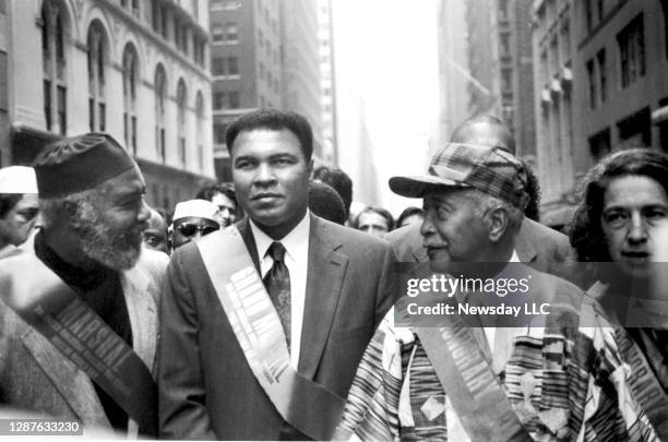 Boxer Muhammad Ali marches in the Islamic Day Parade with New York City Mayor David Dinkins down Madison Avenue in Manhattan on September 27, 1992.