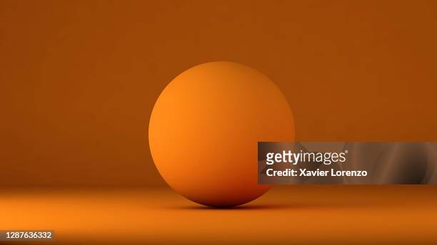 3d ball in orange background - sphere stock pictures, royalty-free photos & images