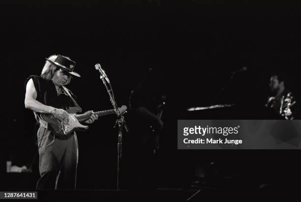 Stevie Ray Vaughan plays his guitar during a concert at the Red Rocks Amphitheater on June 17, 1987 in Morrison, Colorado. The image was tinted by...