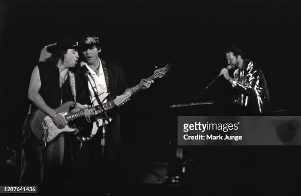 Stevie Ray Vaughan and Tommy Shannon sing and play guitar in a Double Trouble band performance during a Live Alive Tour concert at Red Rocks...