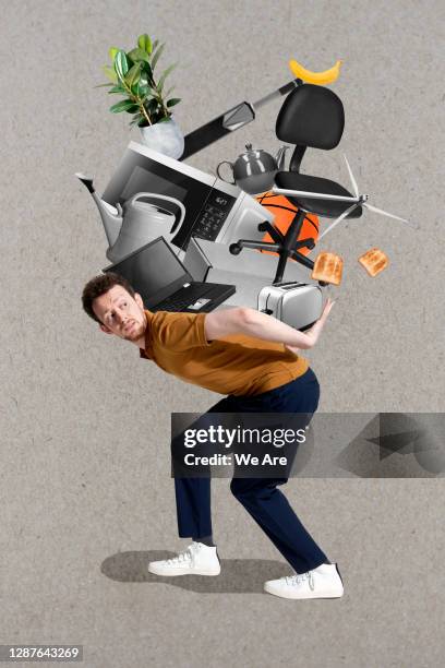 man carrying stack of household items - voll geladen stock-fotos und bilder