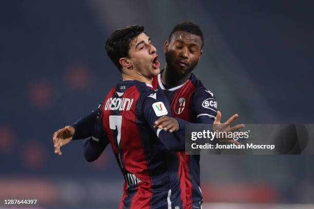 Riccardo Orsolini of Bologna FC celebrates with team mate Stefano Denswil after scoring to give the side a 2-1 lead during the Coppa Italia match...