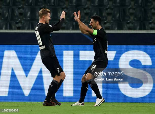 Nico Elvedi of Borussia Moenchengladbach celebrates with Lars Stindl after scoring their team's second goal during the UEFA Champions League Group B...