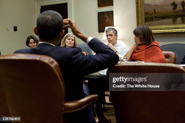 In this handout provided by the White House, President Barack Obama meets with Education Secretary Arne Duncan and staff in the Roosevelt Room of the...