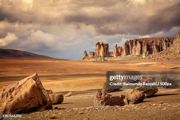panoramic view of rock formations against sky - atacama stock-fotos und bilder